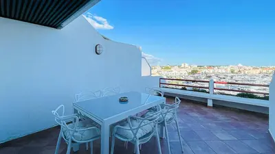 a table and chairs on a balcony with a view at Penthouse Triplex Marina T2 by HsR Vilamarina in Quarteira