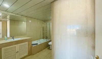 a bathroom with a sink and a toilet and a mirror at Penthouse Triplex Marina T2 by HsR Vilamarina in Quarteira