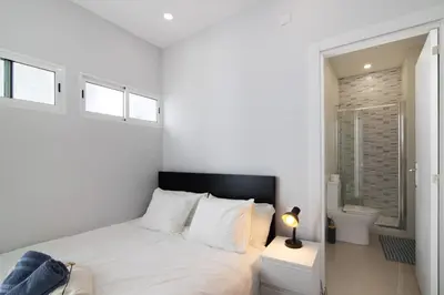 a bedroom with a white bed with towels on it at Skipper House in Loulé