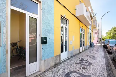 two cars parked in a parking lot in a city at Skipper House in Loulé