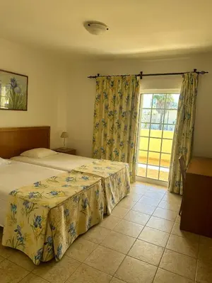 a bedroom with a bed and a large window at Benvindo Villa by Umbral in Albufeira