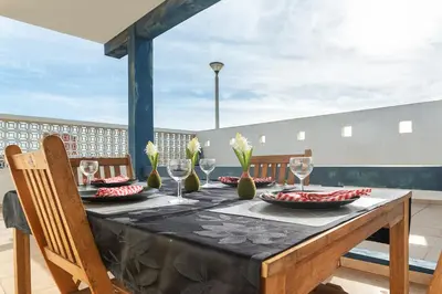 a table with a black table cloth and wine glasses at Blife Bandaya private apartment in Faro