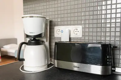 a coffeemaker next to a microwave on a counter at Blife Bandaya private apartment in Faro