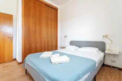 a bedroom with a bed with two towels on it at Blife Bandaya private apartment in Faro