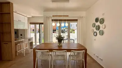 a kitchen and dining room with a table and chairs at Lotus by Check-in Portugal in Quarteira
