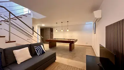 a living room with a billiard table and stairs at Lotus by Check-in Portugal in Quarteira
