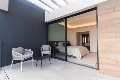 a bedroom with a bed and a glass wall at Buganvilia - Luxury villa - private pool by HD in Vale Formoso