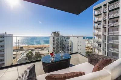 an apartment balcony with a view of the ocean at Terracos de Quarteira Blue by Real Properties in Quarteira