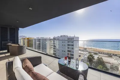a living room with a view of the ocean at Terracos de Quarteira Blue by Real Properties in Quarteira