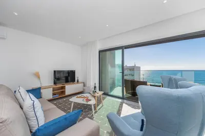 a living room with a view of the ocean at Terracos de Quarteira Blue by Real Properties in Quarteira