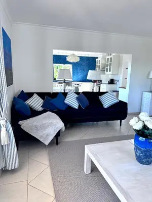 a living room with a blue couch and a table at Algarve country villa near Loulé, stunning views in Romão
