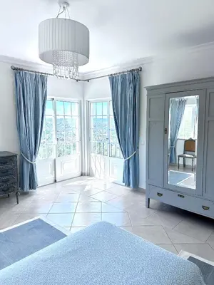 a bedroom with blue curtains and a bed with a mirror at Algarve country villa near Loulé, stunning views in Romão