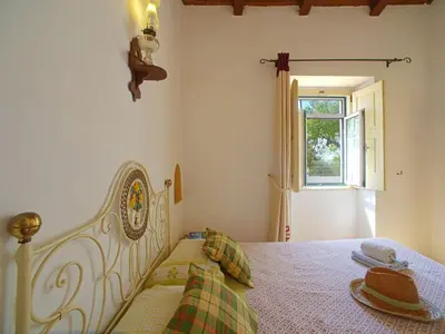 a white bed in a room with a window at Holiday Home Monte da Calma by Interhome in Albufeira