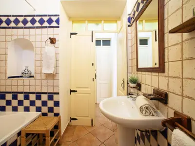 a bathroom with a sink and a tub and a mirror at Holiday Home Monte da Calma by Interhome in Albufeira