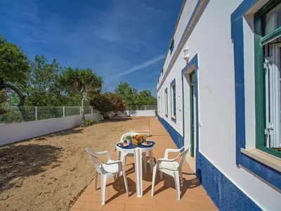 a patio with a table and chairs on the side of a building at Holiday Home Monte da Calma by Interhome in Albufeira