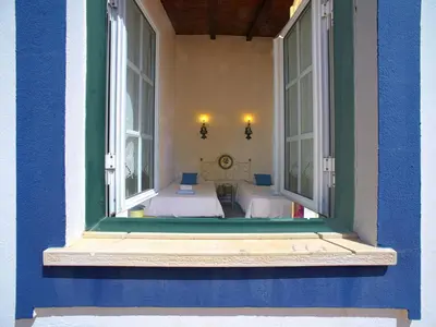 a blue building with a window with two beds at Holiday Home Monte da Calma by Interhome in Albufeira