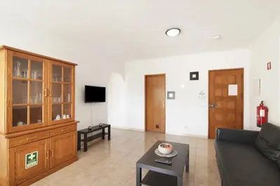 a living room with a couch and a entertainment center at Hilcity in Albufeira