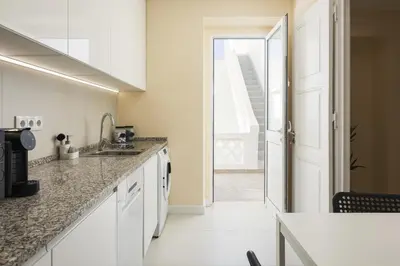 a kitchen with a sink and a counter top at City Rooms Guest House by HD in Faro