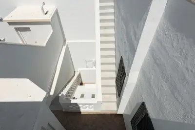 a view of a staircase in a white building at City Rooms Guest House by HD in Faro