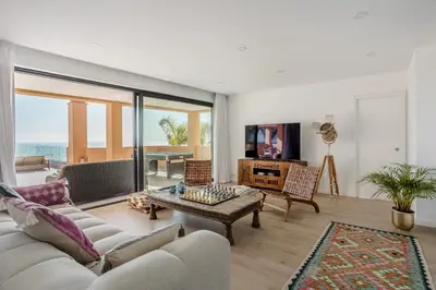 a living room with a couch and a table at Villa Oceânica in Albufeira