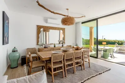 a dining room with a table and chairs at Villa Oceânica in Albufeira