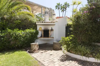 a house with a fireplace in the middle of a yard at Vila Norte - Private Pool by HD PROPERTIES in Vilamoura