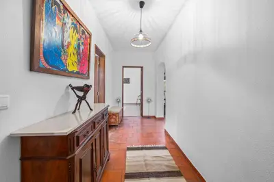 a hallway of a home with a painting on the wall at Helena's House Sea View in Albufeira