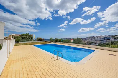 a swimming pool on the roof of a house at Helena's House Sea View in Albufeira