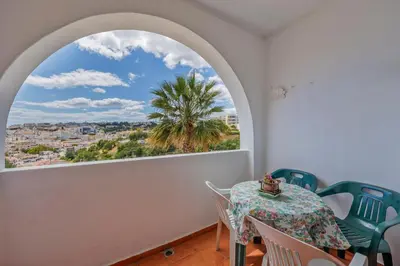 a room with a table and chairs and a window at Helena's House Sea View in Albufeira