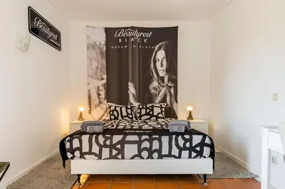 a bedroom with a bed with a poster on the wall at OURA WHITE VIEW Beach 2 min walk sea in Albufeira