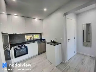 a kitchen with white cabinets and a stove top oven at ELdorado JArdim open view beach 5 minutes foot in Albufeira