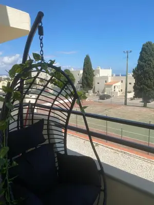 a blue table and chairs on a balcony with a view at ELdorado JArdim open view beach 5 minutes foot in Albufeira