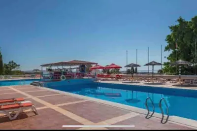 a swimming pool with blue water in a resort at ELdorado JArdim open view beach 5 minutes foot in Albufeira