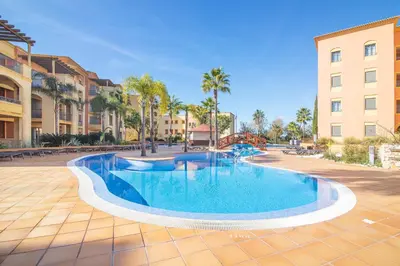 a swimming pool in the middle of a courtyard with buildings at The Residences Vilamoura, Apartment Melissa in Vilamoura