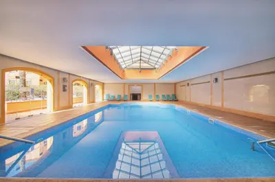 a swimming pool with a skylight in a building at The Residences Vilamoura, Apartment Melissa in Vilamoura