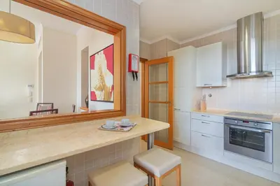a kitchen with a counter and a mirror at The Residences Vilamoura, Apartment Melissa in Vilamoura