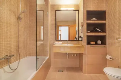 a bathroom with a tub and a sink and a shower at The Residences Vilamoura, Apartment Melissa in Vilamoura