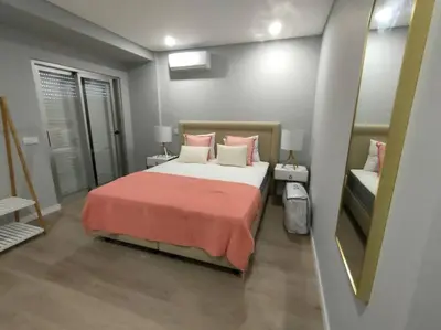 a bedroom with a large bed with a red blanket at Faro Main Avenue Apartment II in Faro