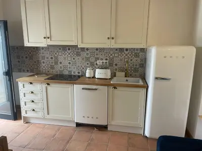 a kitchen with white cabinets and a white refrigerator at Monte Gerações - Heated pool - Typical Algarvian - close to Quinta Lago, Vale Lobo and Vilamoura in Almancil