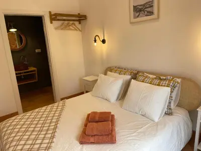 a bedroom with a bed with two towels on it at Monte Gerações - Heated pool - Typical Algarvian - close to Quinta Lago, Vale Lobo and Vilamoura in Almancil