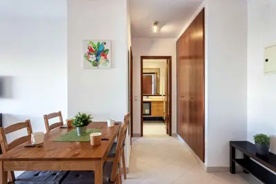 a dining room with a wooden table and chairs at Blife Amorya private apartment in Faro