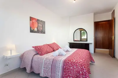 a bedroom with a bed with red pillows and a mirror at Blife Amorya private apartment in Faro