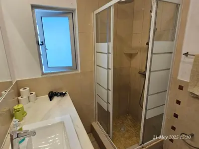 a bathroom with a glass shower and a sink at Blife Ceriya private apartment in Faro