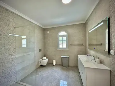 a bathroom with a toilet and a sink and a shower at Quarteira Premium Villa With Pool by Homing in Quarteira