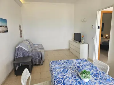 a small living room with a table and a couch at Blife Vistaya private apartment in Faro