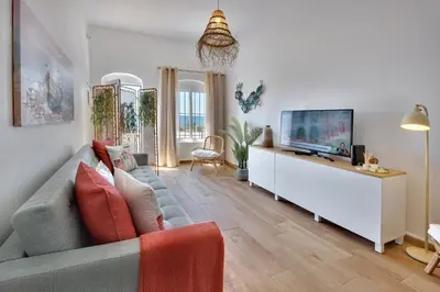 a living room with a couch and a flat screen tv at Beach Residence Old Town in Albufeira