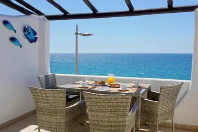 a table and chairs with a view of the ocean at Beach Residence Old Town in Albufeira