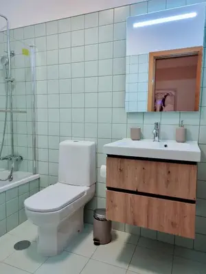 a bathroom with a toilet and a sink and a mirror at Casa Santos in Albufeira