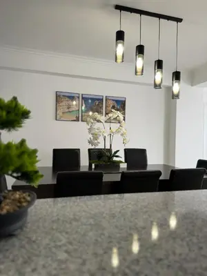 a dining room with chairs and a table and lights at Princess Retreat Beautiful Modern Aprt 2 min walk from Quarteira Beach in Quarteira