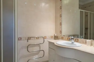 a bathroom with a sink and a mirror at VILAMOURA Two Bedroom Near Praia Falésia in Quarteira